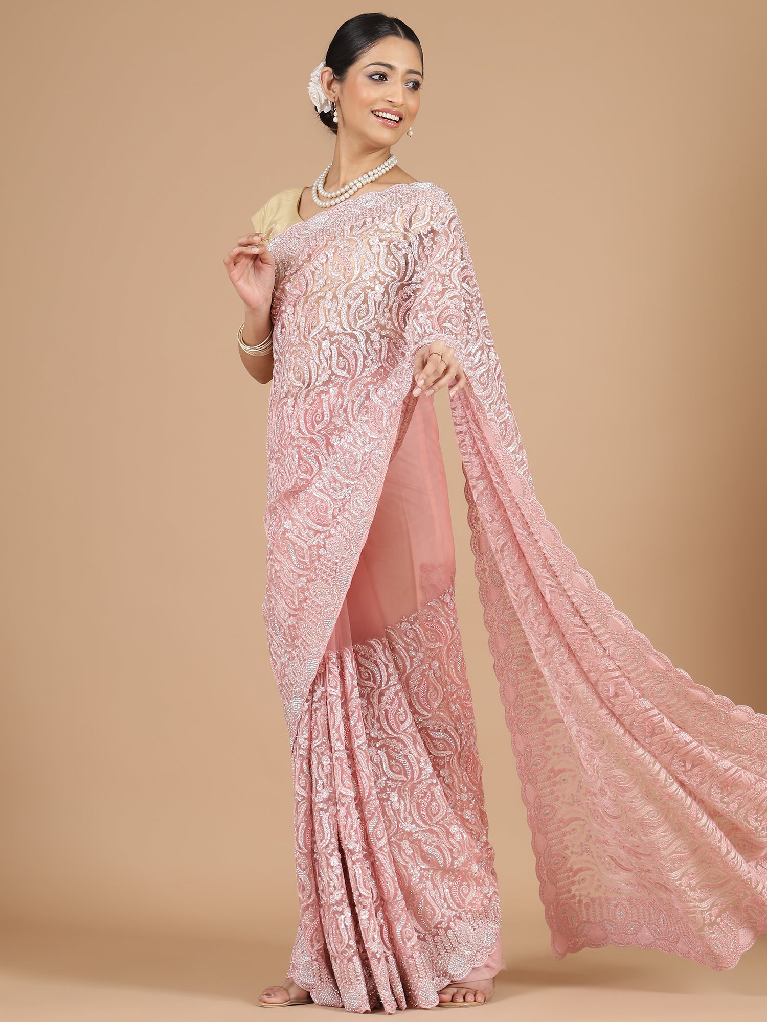 Exquisite Peach Net Saree with Stone-Studded Floral Work