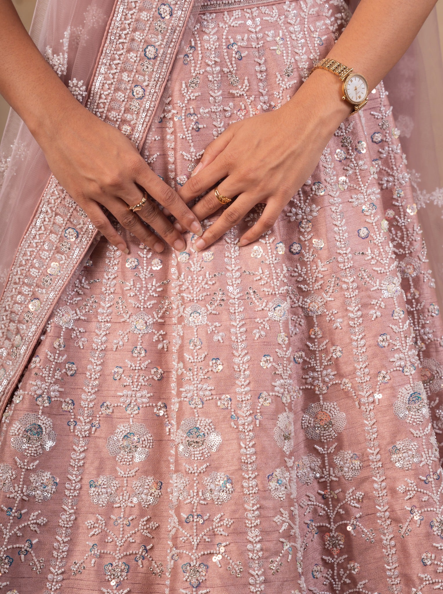 Detail of the blush pink net lehenga skirt showing silver sequin and floral thread embroidery