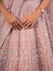Detail of the blush pink net lehenga skirt showing silver sequin and floral thread embroidery