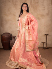 Side view of a blush pink raw silk Anarkali with the gold-bordered dupatta draped over the arm
