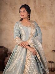 Model in a pale blue raw silk Anarkali with the dotted gold-bordered dupatta draped across the front