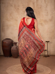 Back view of a maroon tussar silk saree showing the paisley-patterned pallu and back of the blouse
