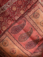 Detail of the paisley and floral print on the pallu of the maroon tussar silk saree