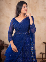 Half-length view of a royal blue net lehenga with a V-neck blouse, pre-draped dupatta and beaded tassels