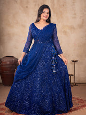 Full-length view of a royal blue net lehenga with sequin work, sheer sleeves and a dupatta over one shoulder