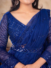 Close-up of the V-neck blouse and draped dupatta on a royal blue sequinned net lehenga