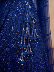 Detail of the royal blue beaded tassel latkan against the sequinned net skirt