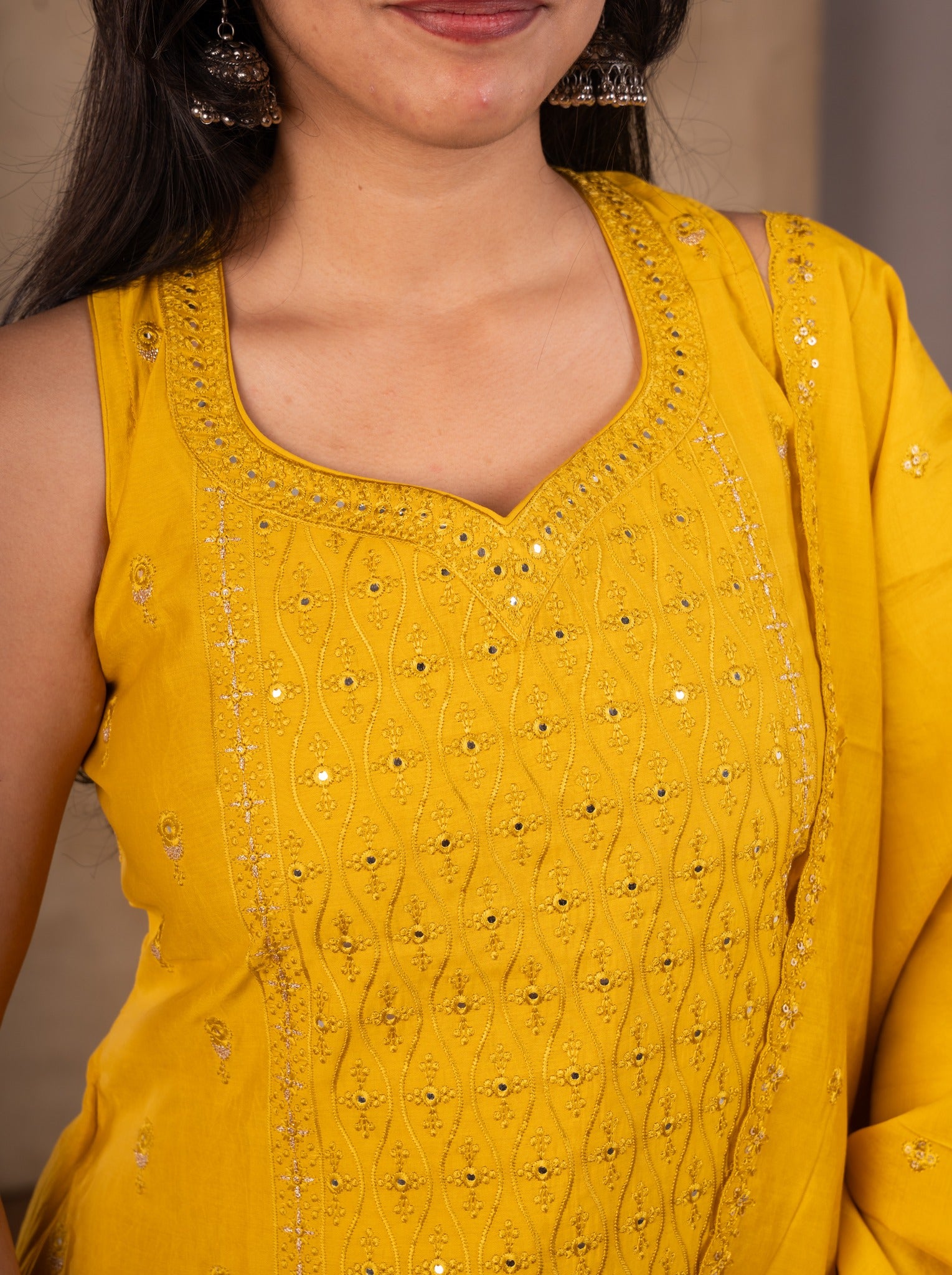 Detail of the sweetheart neckline with embroidered trim on the yellow cotton kurta