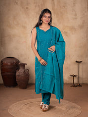 Front view of a model in a Rama teal cotton salwar suit with a sleeveless embellished kurta, matching trousers and a dupatta