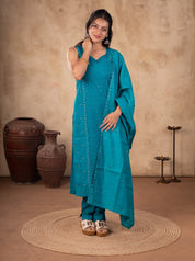 Model holding the dupatta of a Rama teal cotton salwar suit with scattered motifs