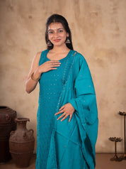 Half-length view of a sleeveless Rama teal cotton kurta with sequin detailing and matching dupatta