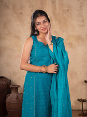 Model smiling in a Rama teal cotton salwar suit with the dupatta held over one shoulder