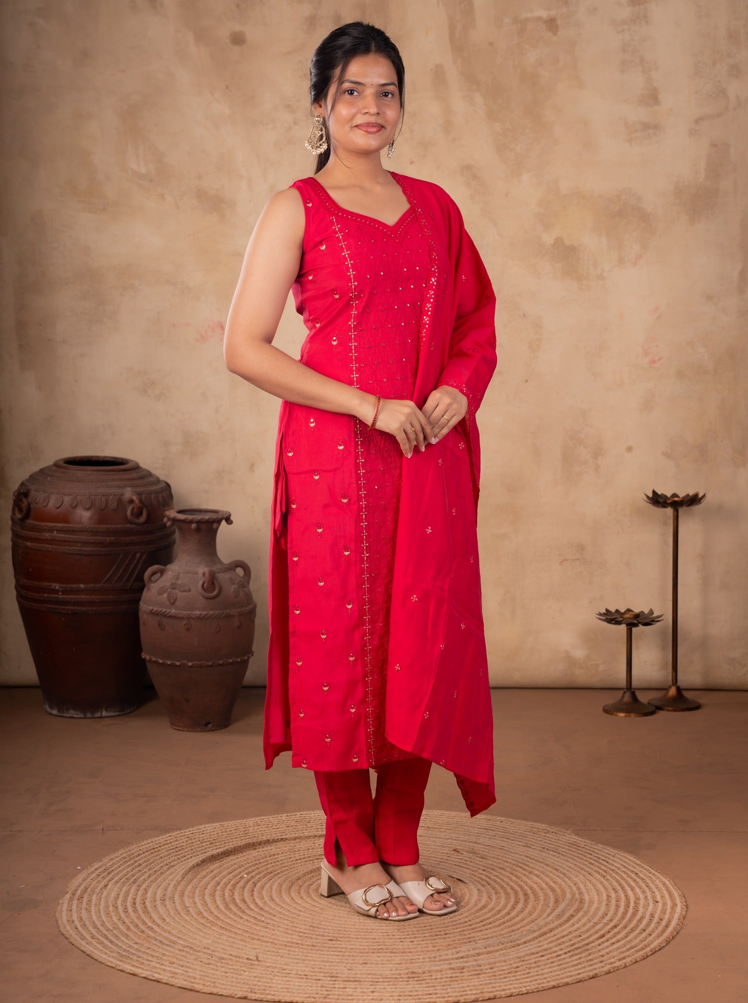 Full-length view of a Rani pink cotton salwar suit with a sleeveless kurta and matching trousers