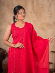 Half-length view of a Rani pink cotton kurta with sequin detailing and the dupatta held out