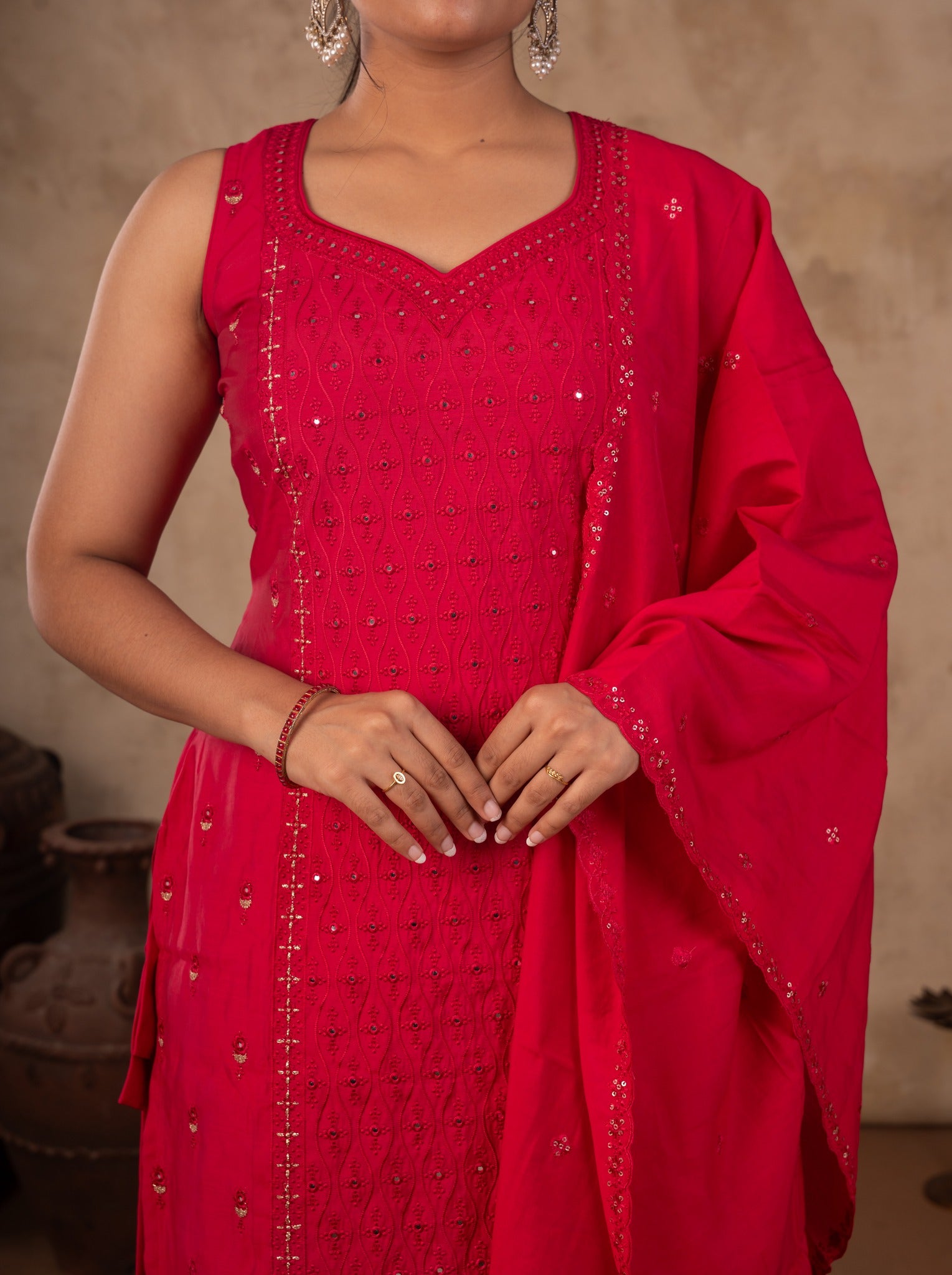 Close-up of the sleeveless Rani pink cotton kurta with an embroidered sweetheart neckline and dupatta