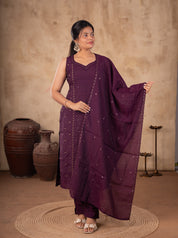 Front view of a model in a purple cotton salwar suit with a sleeveless embellished kurta and a dupatta held out