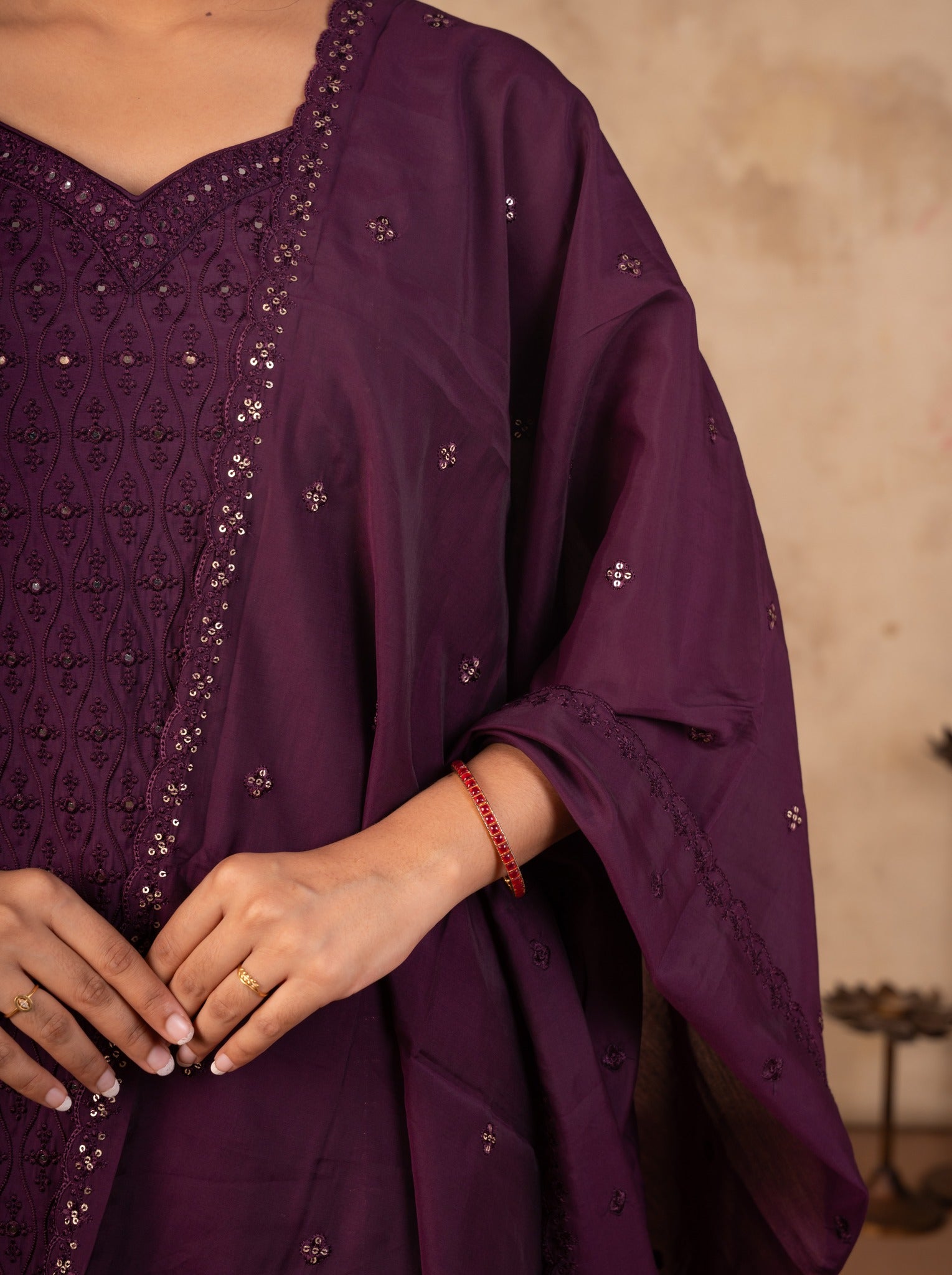 Detail of the embroidered placket and sequin motifs on the purple cotton kurta and dupatta