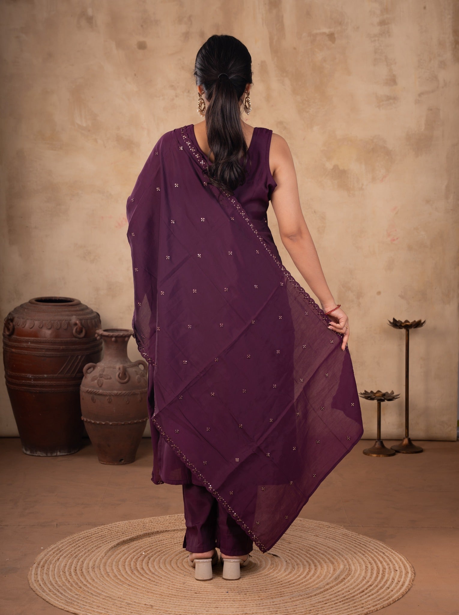 Back view of a purple cotton salwar suit with the dupatta held out behind