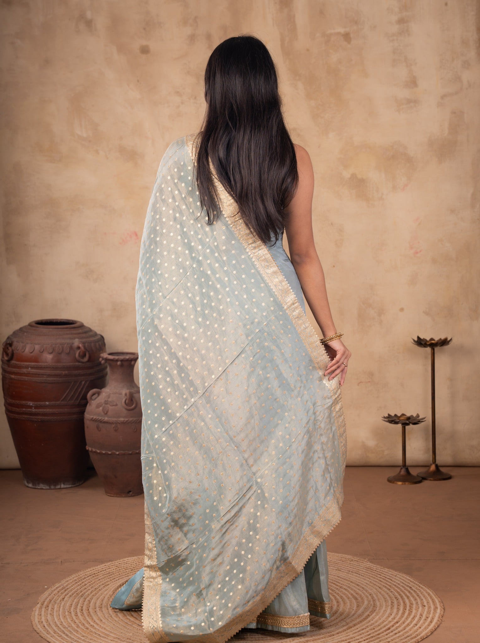 Back view of a sea green silk salwar suit with the dotted dupatta draped across the back