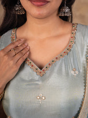 Close-up of the embellished V-neckline on the sea green silk kurta