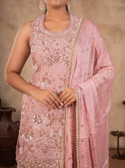 Close-up of the sequin and thread-embroidered peach silk kurta with an embellished neckline