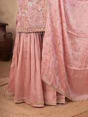 Detail of the flared peach sharara trousers and the dupatta's lace border