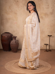 Side view of a white silk salwar suit with the dupatta draped over the shoulder