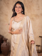 Model smiling in a white silk salwar suit with the gold-bordered dupatta held across her body