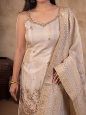 Close-up of the strappy white silk kurta with floral embroidery at the hem and the dupatta draped over the shoulder