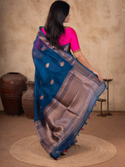 Back view of a blue Banarasi silk saree showing the woven pallu and a bright pink blouse