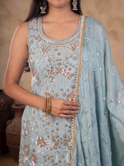 Half-length view of a sleeveless sage green kurta with sequin floral embroidery and a dupatta with decorative trim