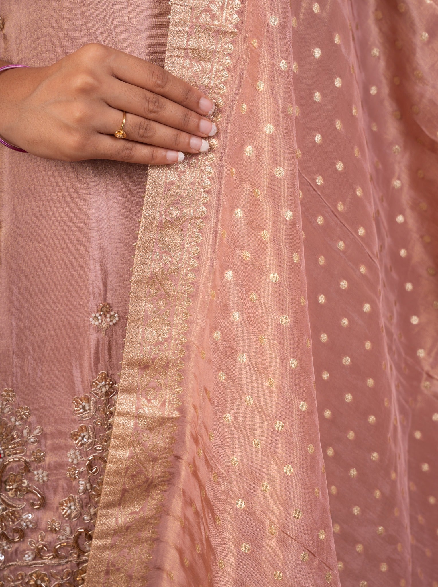 Detail of the dotted weave and gold lace border on the blush pink dupatta