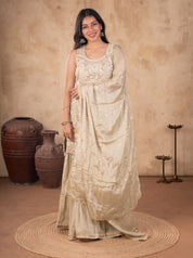 Model in a light olive green georgette sharara suit with the dupatta draped across her body