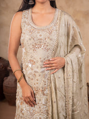 Close-up of the floral sequin embroidery and embellished neckline on a light olive green kurta