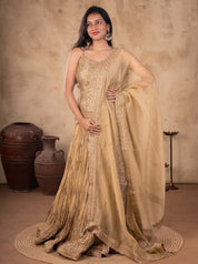 Front view of a model in a pista organza lehenga with a pleated embroidered skirt, strappy choli and sheer dupatta