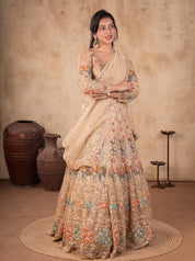 Front view of a model in a pista organza lehenga with multicoloured floral embroidery, an embellished long-sleeved blouse and dupatta