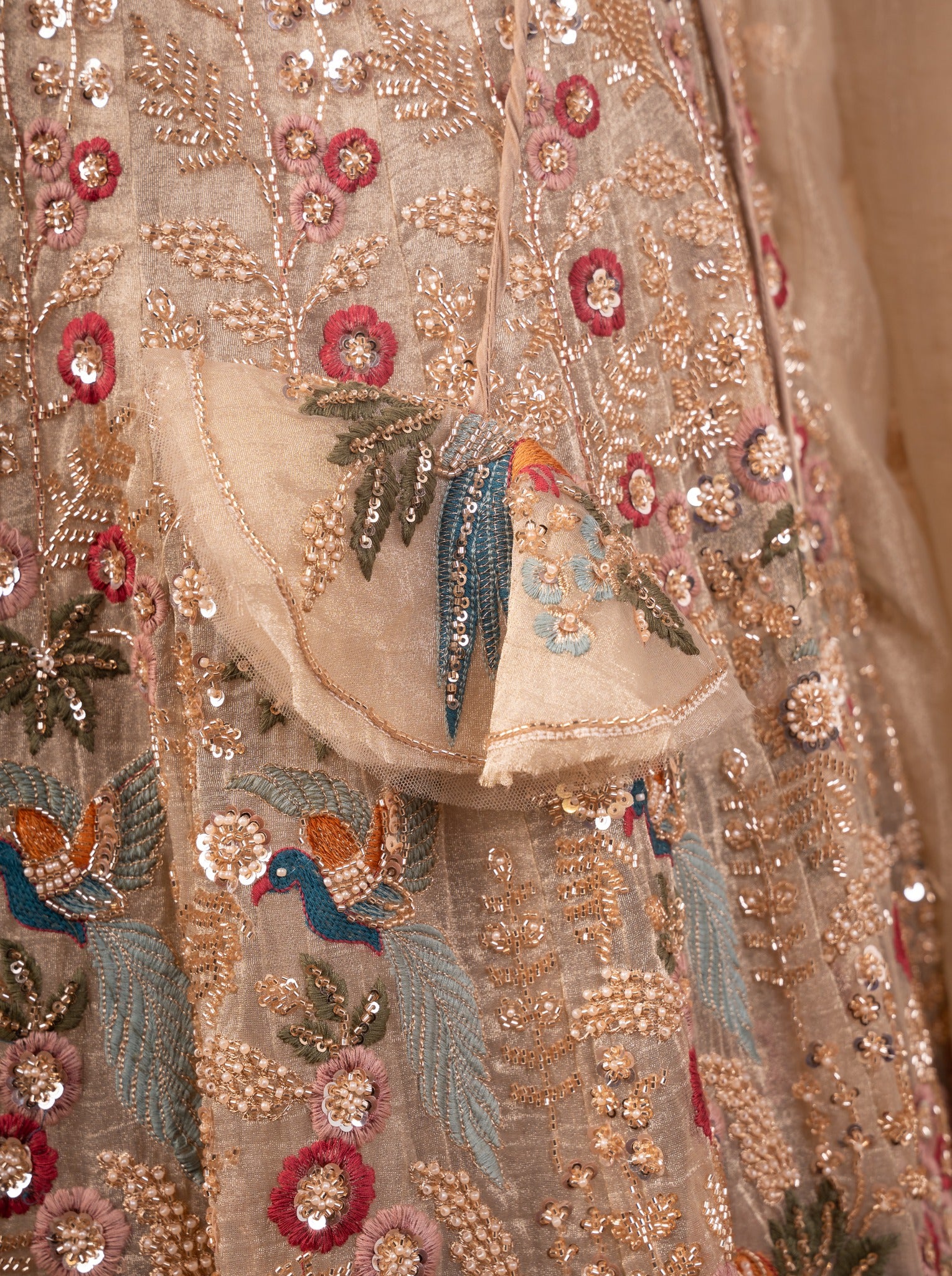 Detail of the sequin, bead and bird-motif embroidery on the pista organza skirt