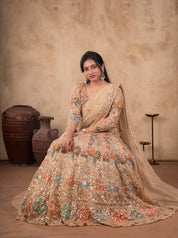 Model seated in a pista organza lehenga with the embroidered skirt spread around her