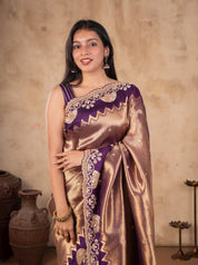 Model in a bronze-toned saree with a purple sleeveless blouse and embellished border