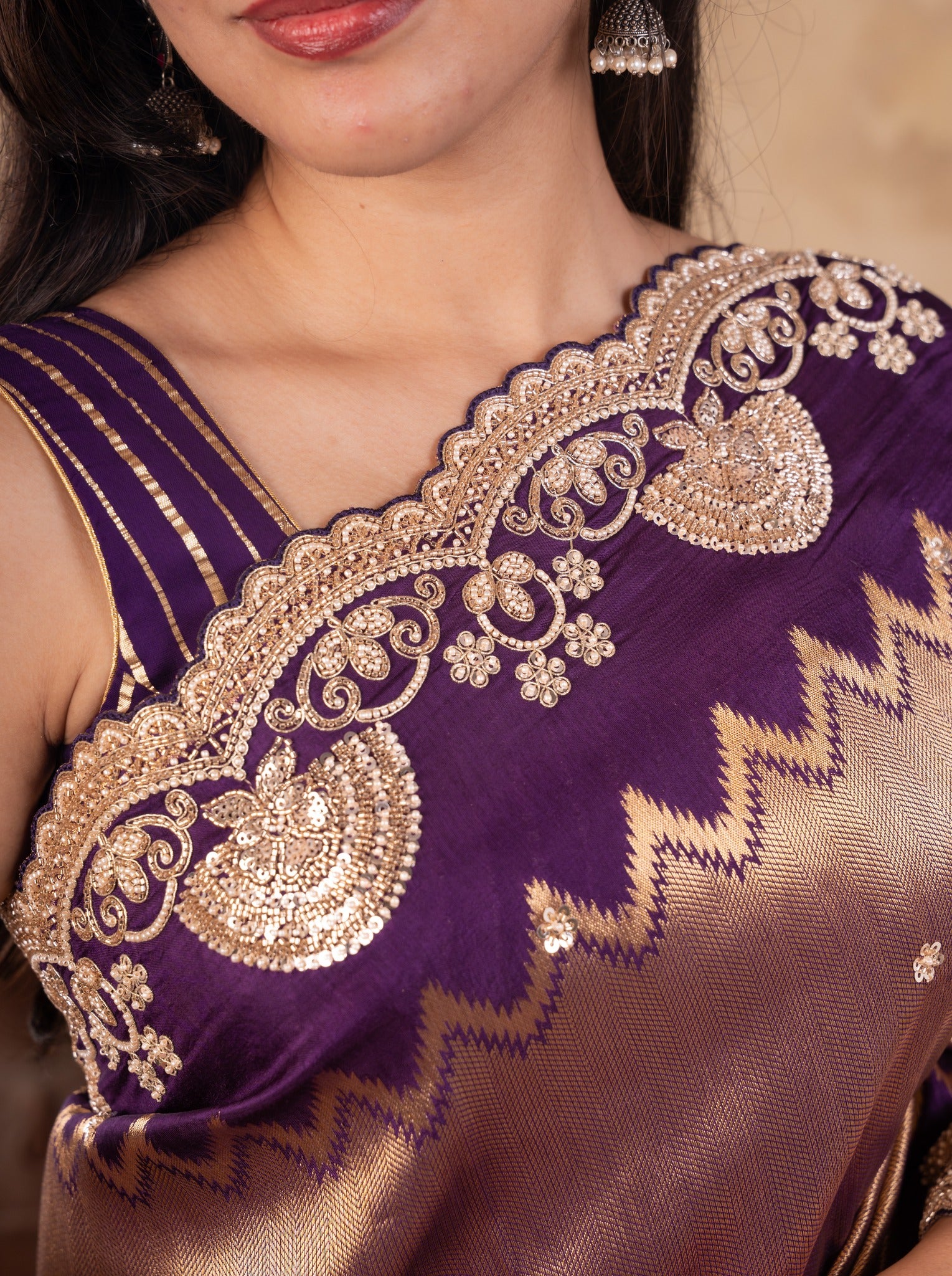 Detail of the gold paisley and floral embroidery on the purple border and blouse