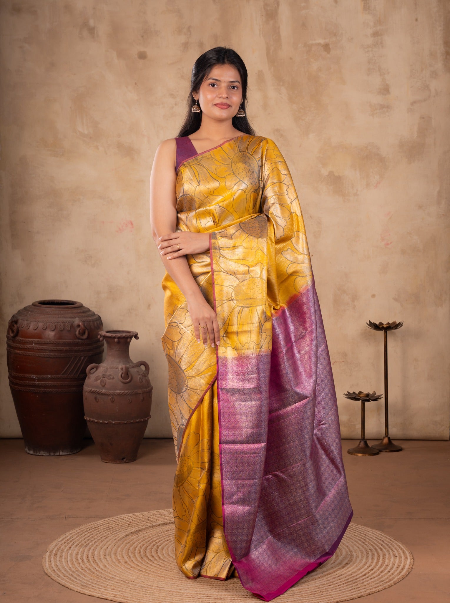 Front view of a mustard soft silk saree with a pink woven pallu and a purple sleeveless blouse