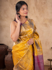 Half-length view of a mustard soft silk saree with floral woven motifs and a purple blouse