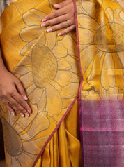 Detail of the large floral weave on the mustard soft silk saree and its pink border