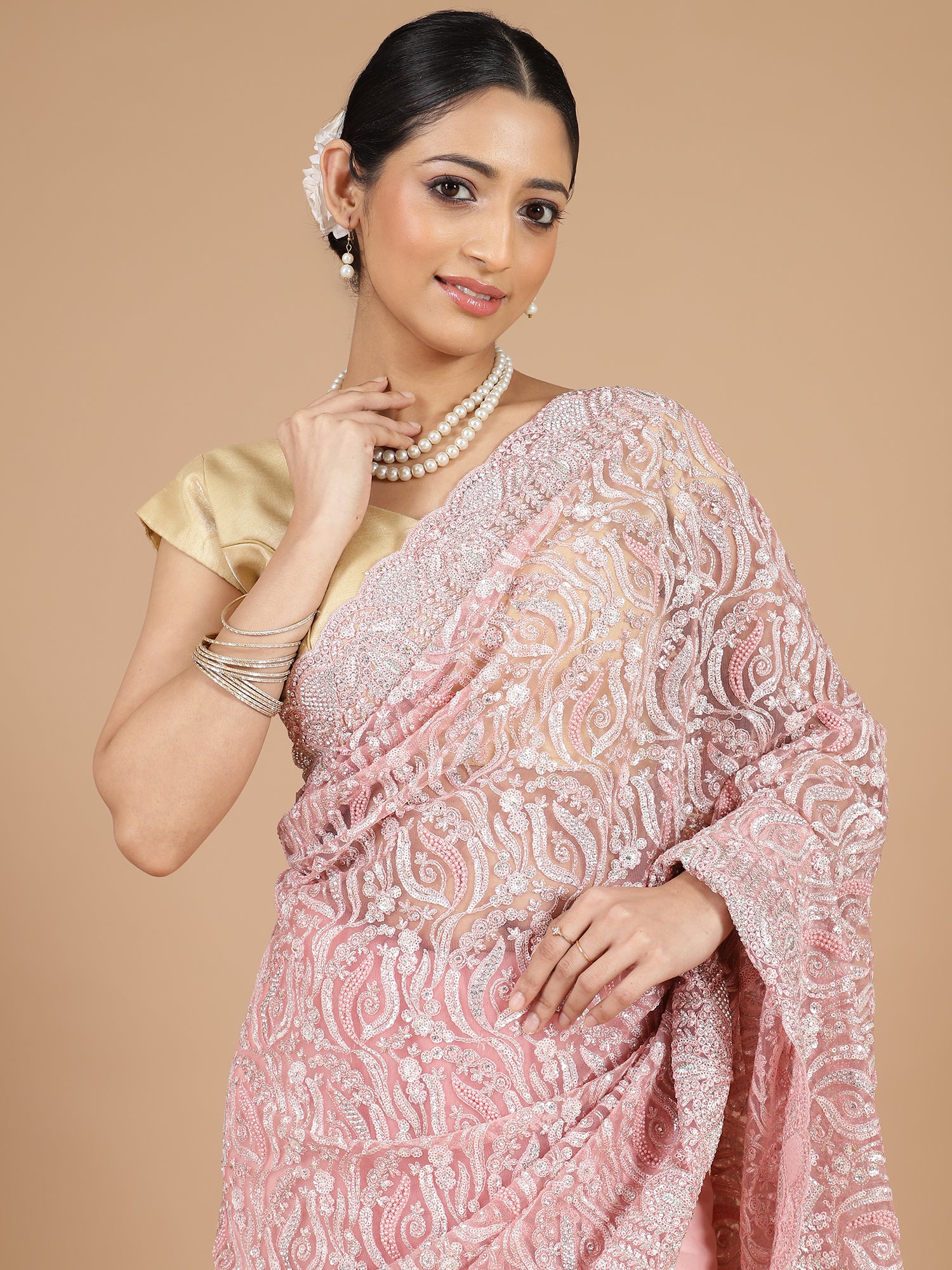 Exquisite Peach Net Saree with Stone-Studded Floral Work